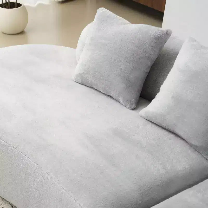 Modern and simple curved flannelette sofa. Creative multi-seater for the living room, with a combination of pillows.