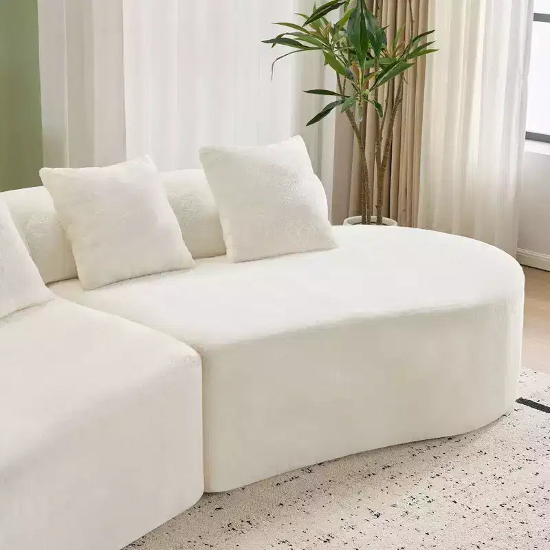 Modern and simple curved flannelette sofa. Creative multi-seater for the living room, with a combination of pillows.