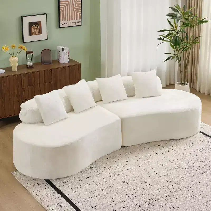 Modern and simple curved flannelette sofa. Creative multi-seater for the living room, with a combination of pillows.