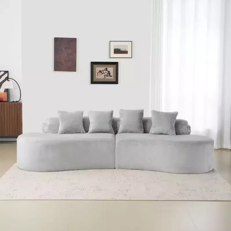 Modern and simple curved flannelette sofa. Creative multi-seater for the living room, with a combination of pillows.