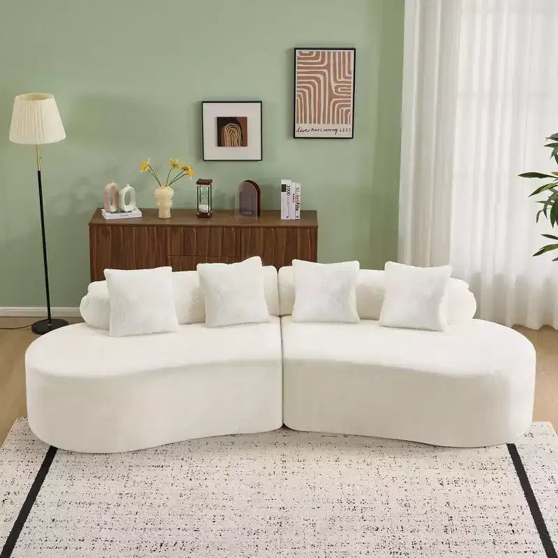 Modern and simple curved flannelette sofa. Creative multi-seater for the living room, with a combination of pillows.