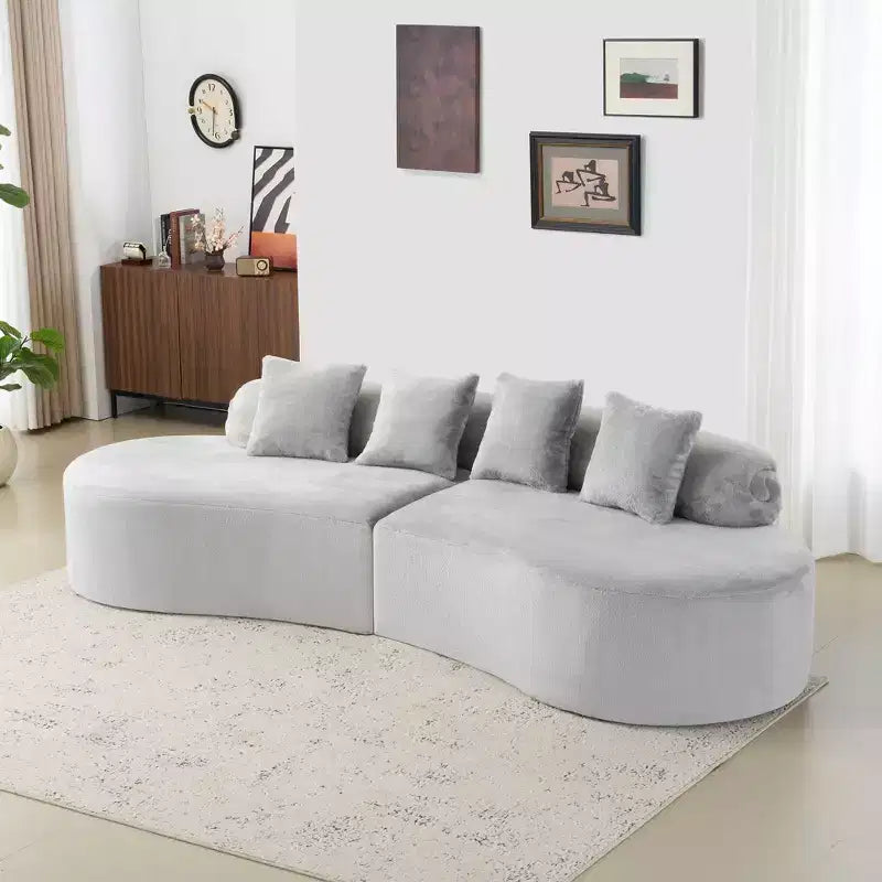 Modern and simple curved flannelette sofa. Creative multi-seater for the living room, with a combination of pillows.