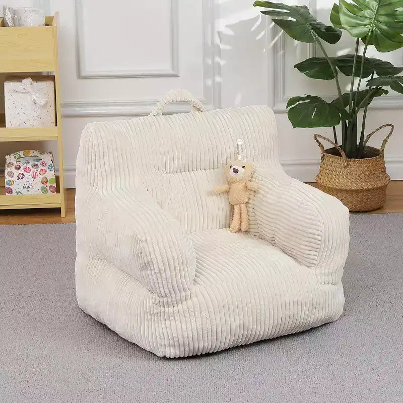 Pink corduroy beanbag sofa with plush cushion, a cosy floor seat for bedrooms and playrooms. Softly supportive design with handles for easy carrying.