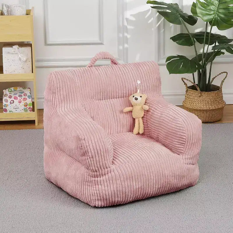 Pink corduroy beanbag sofa with plush cushion, a cosy floor seat for bedrooms and playrooms. Softly supportive design with handles for easy carrying.